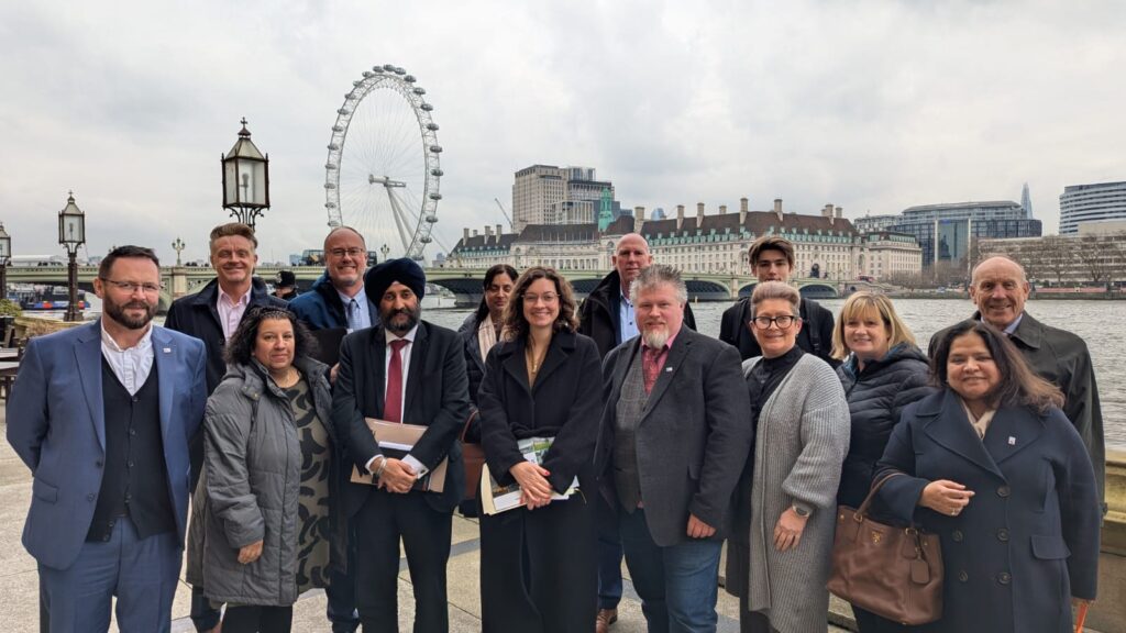 Anjali and the other Sandwell Business Ambassadors on the banks of the Thames, with Sarah Coombes MP. The London Eye and County Hall are in the background